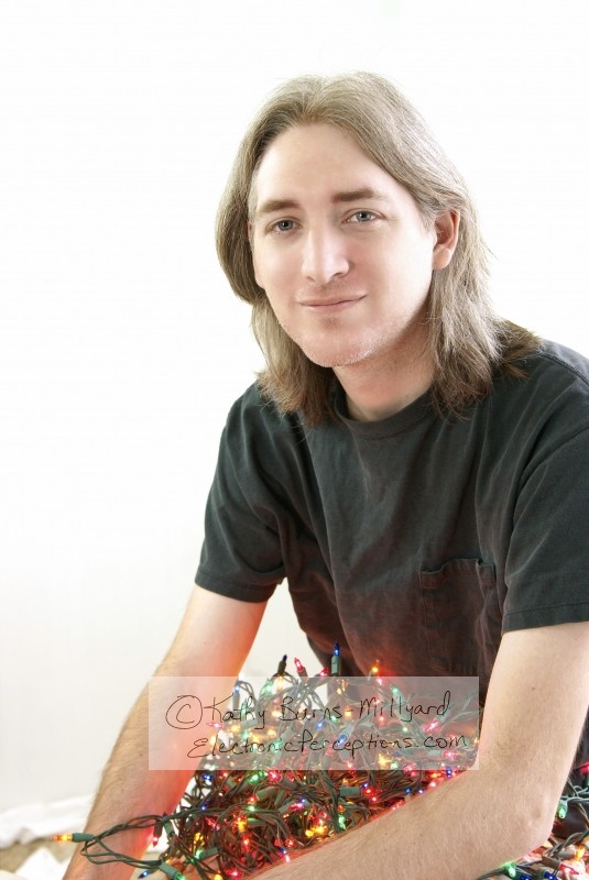 Stock Photo: Man With Christmas Lights - by Kathy Burns-Millyard