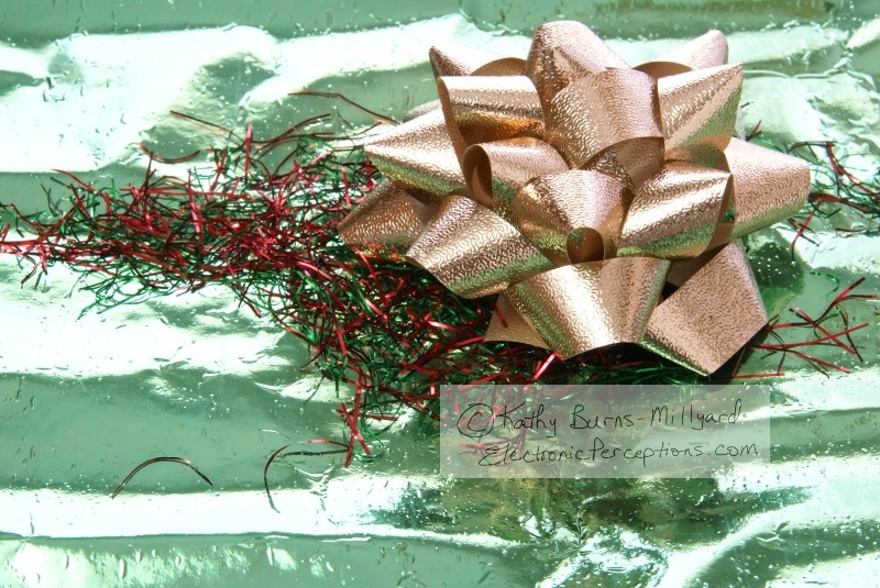 Stock Photo: Gold Bow on Green - by Kathy Burns-Millyard